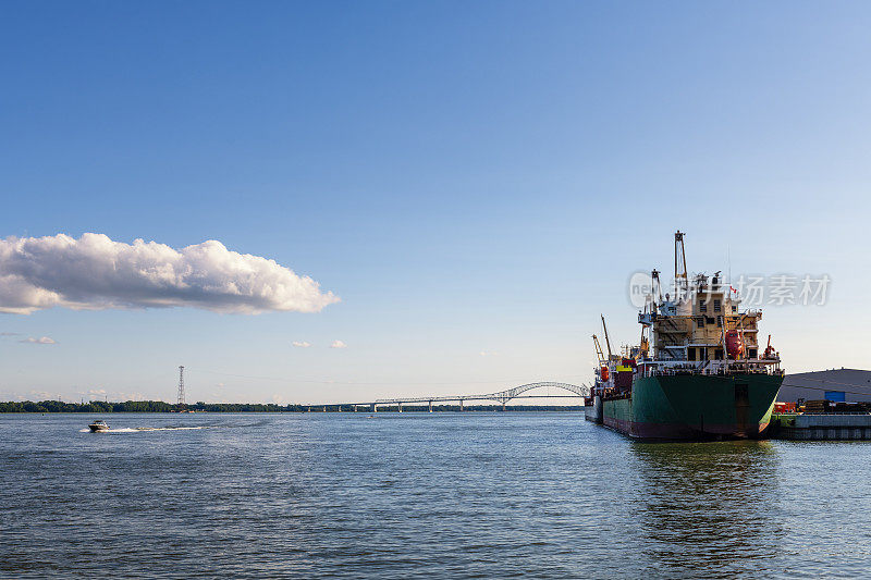 container ship and a motorboat at harbor in Trois-Rivieres in Canada